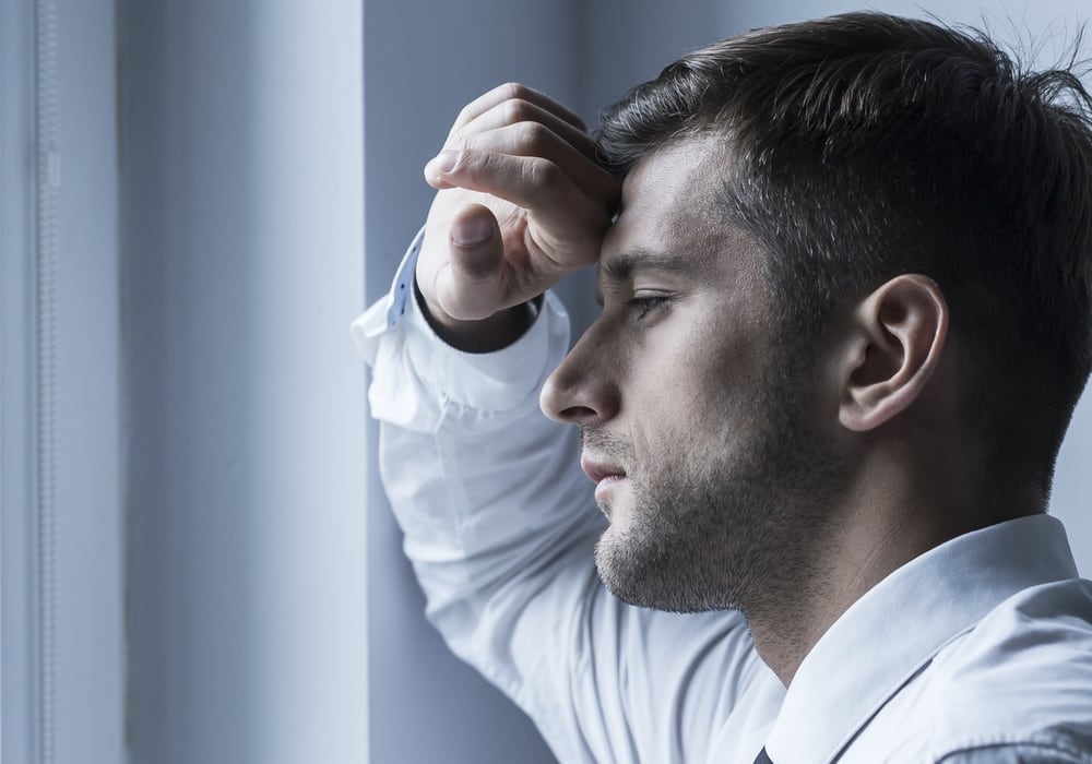 anxious-man-looking-out-window anxious man looking out window